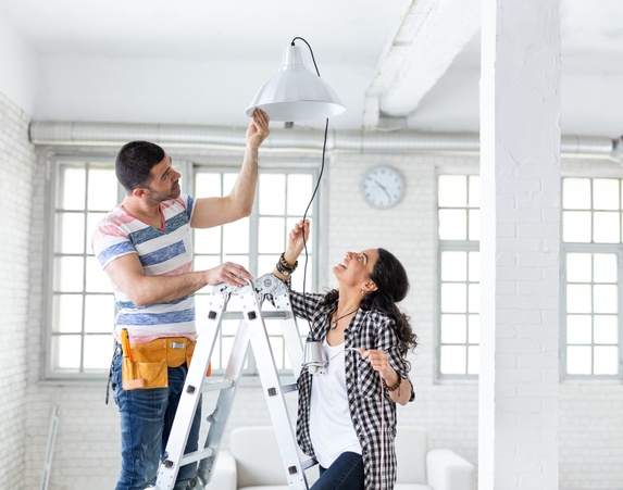 Happy Couple installing the ceiling light